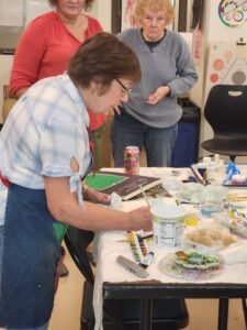 Mary Sue Schwab demonstrating painting techniques