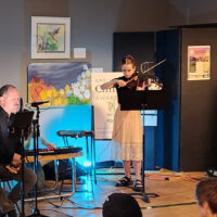 Violinist and poetry reading at the reception for Artists for climate Awareness arts how April 12, 2024