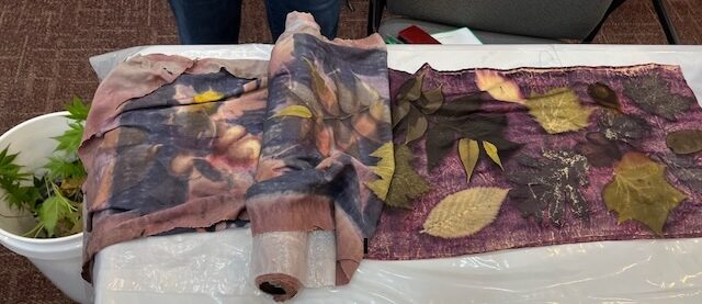 A partially rolled silk with leaf prints